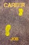 Yellow footsteps on sidewalk from Job to Career message. Concept image