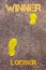 Yellow footsteps on sidewalk from Loser to Winner message. Concept image