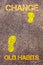 Yellow footsteps on sidewalk from Old Habits to Change message. Concept image