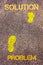 Yellow footsteps on sidewalk from Problem to Solution message. Concept image