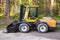 Yellow forklift with general bucket stands