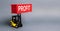 A yellow forklift lifts a red container labeled Profit. The concept of raising profits and income from successful investments