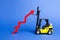 A yellow forklift raises a big red arrow up. Growth in production rates and development of industry and infrastructure. Increased