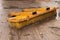 Yellow Forklift road sweeper brush attachment part in rainy yard