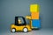 Yellow forklift toy load color cubes. Toys for children. Small forklift loader and three cubes