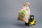 Yellow forklift truck carries a big bag of money. Attracting investment in the development and modernization of production