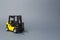 Yellow forklift truck on gray background. Warehouse equipment, vehicle. Logistics and transport infrastructure, industry