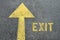 Yellow forward road sign with Exit word on the asphalt road.