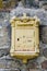 Yellow French Mailbox in Stone Wall