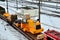 The yellow and front loader disassembled into parts is loaded onto a cargo railway platform.