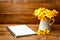 Yellow gardenia flower in vase with note book