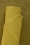 Yellow genuine leather roll.real leather set. Leather in rolls on a dark beige leather surface.Hobby and craft material