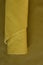 Yellow genuine leather roll.real leather set. Leather in rolls on a dark beige leather surface.Hobby and craft material