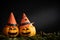 Yellow ghost pumpkins with witch hat in dark room