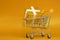 Yellow Gift box in Shopping cart on yellow background - Love Valentine , birthday , or special thank shopping - marketing advertis