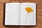 Yellow gingko leaf on the book on the floor