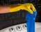 yellow gloved hands in a blue sock near a white washing machine