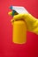 Yellow gloved with a spray bottle on red