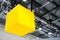 A yellow glowing cube hangs under the ceiling in a hangar