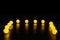 Yellow glowing garland neatly straight-lined balls on a black background with light reflection