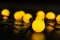 Yellow glowing garland stacked on a black background with light reflection