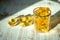 Yellow gold oil vitamin, omega 3 capsules in a glass beaker in t