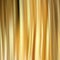 Yellow or golden shiny realistic satin textile texture.