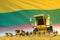 Yellow grain agricultural combine harvester on field with Lithuania flag background, food industry concept - industrial 3D