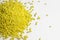 Yellow granules of polypropylene or polyamide on a white background. Plastics and polymers industry. Copy space.