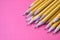 Yellow graphite pencils on a pink background