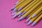 Yellow graphite pencils on a pink background