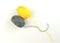 Yellow and gray ball of woolen thread on a white background. Illuminating and Ultimate Gray. Color of the year 2021