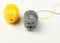 Yellow and gray ball of woolen thread on a white background. Illuminating and Ultimate Gray. Color of the year 2021