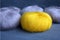 Yellow and gray yarn balls of mohair angora for knitting on the velvet background