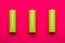 Yellow green AA alkaline batteries on pink background