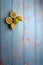 yellow and green lemons, cut and uncut on a light blue background of deteriorated wood