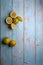 yellow and green lemons, cut and uncut on a light blue background of deteriorated wood