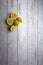 yellow and green lemons, cut and uncut on a light white background of deteriorated wood