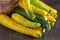 Yellow-green leopard-spotted zucchini. Vegetables on the table. Zucchini harvest.