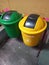 Yellow and green rubbish bins at school