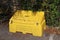 A yellow grit bin in a public car park in readiness for winter driving conditions