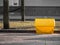 A yellow grit salt box on the street.