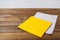 Yellow and grow napkins on old wooden table, food drink concept, mock up