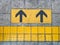 Yellow guiding block brick floor pattern with arrow sign