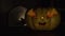 A yellow Halloween pumpkin with a flickering candle inside