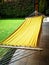 Yellow hammock in the garden of a house