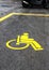Yellow handicap sign in a parking
