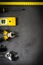 Yellow hardware tools on black concrete background with some space for text