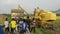 Yellow Harvester machine throw the paddy into lorry.