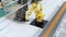 Yellow heavyweight robotic arm carrying vehicles seats for assembly